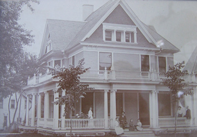 The Victorian house with original double and triple columns and railings before the porch transformation